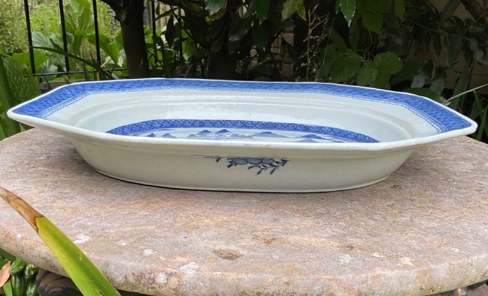 A 19th-century octagonal Chinese porcelain serving platter decorated with a hand-painted blue and white river landscape scene. View III