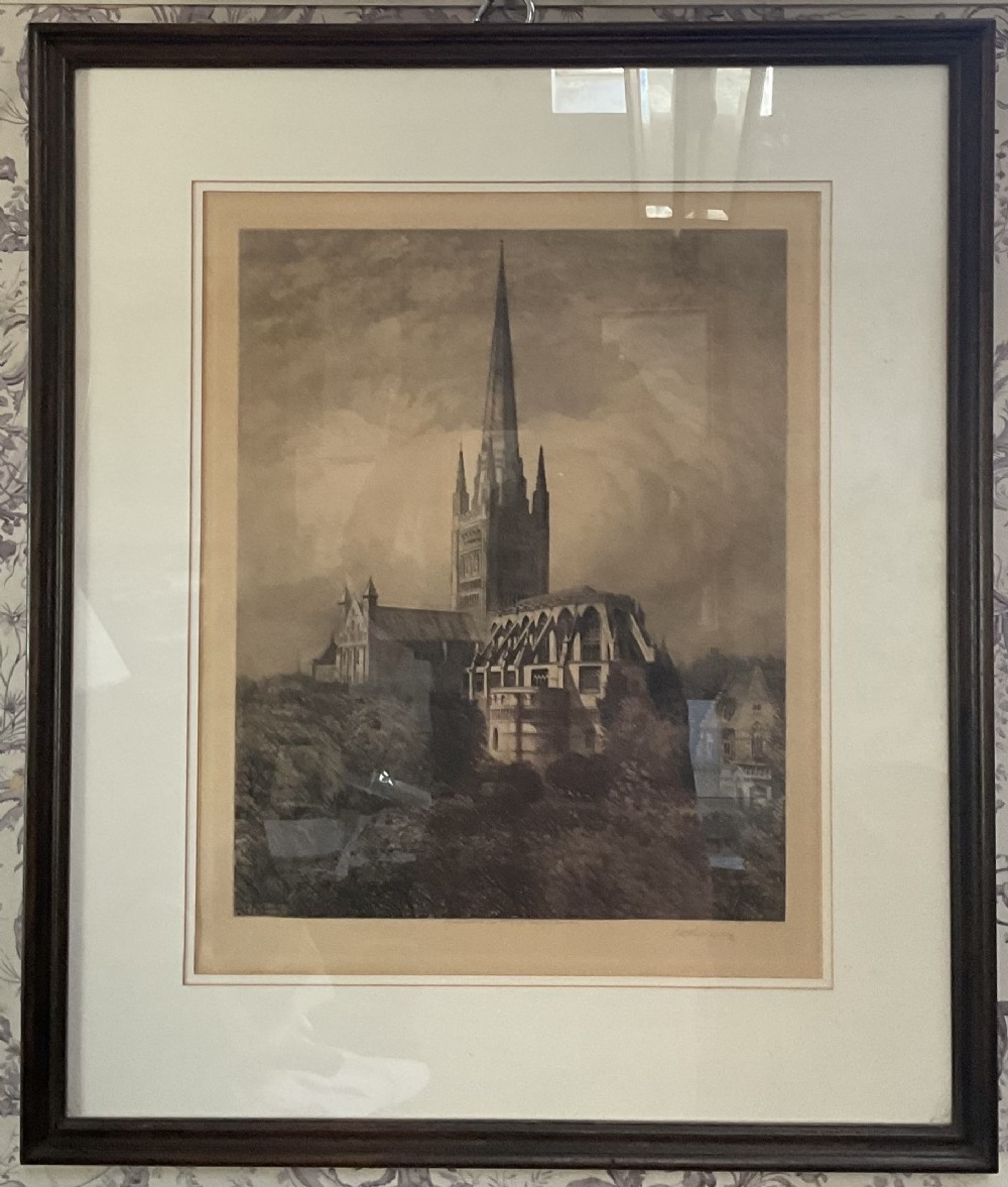 Framed 1892 sepia architectural print depicting Norwich Cathedral with a prominent spire, set within a dark wood frame.