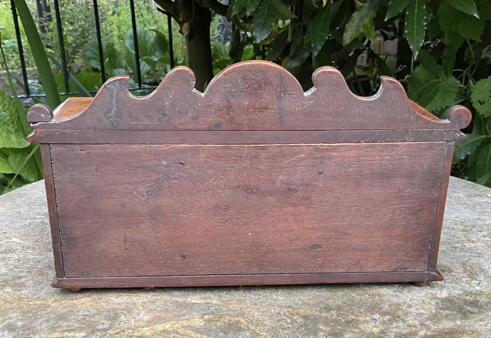 A Victorian mahogany miniature apprentice sideboard featuring a shaped gallery back, breakfront section, and arched panel doors. View VI