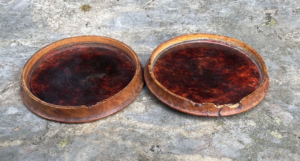 A circular antique pressed maple wooden snuff box lid featuring a raised relief scene of a military battle scene with horses and soldiers. View III