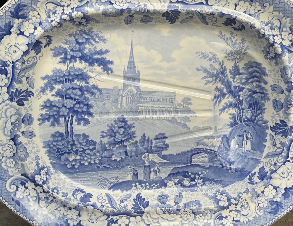 A large oval Victorian blue and white transferware meat platter featuring a central landscape of Glasgow Cathedral with molded drainage channels and a floral border. View II