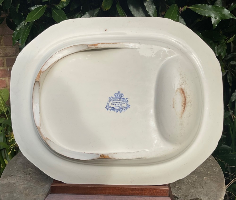 A large oval Victorian blue and white transferware meat platter featuring a central landscape of Glasgow Cathedral with molded drainage channels and a floral border. View III