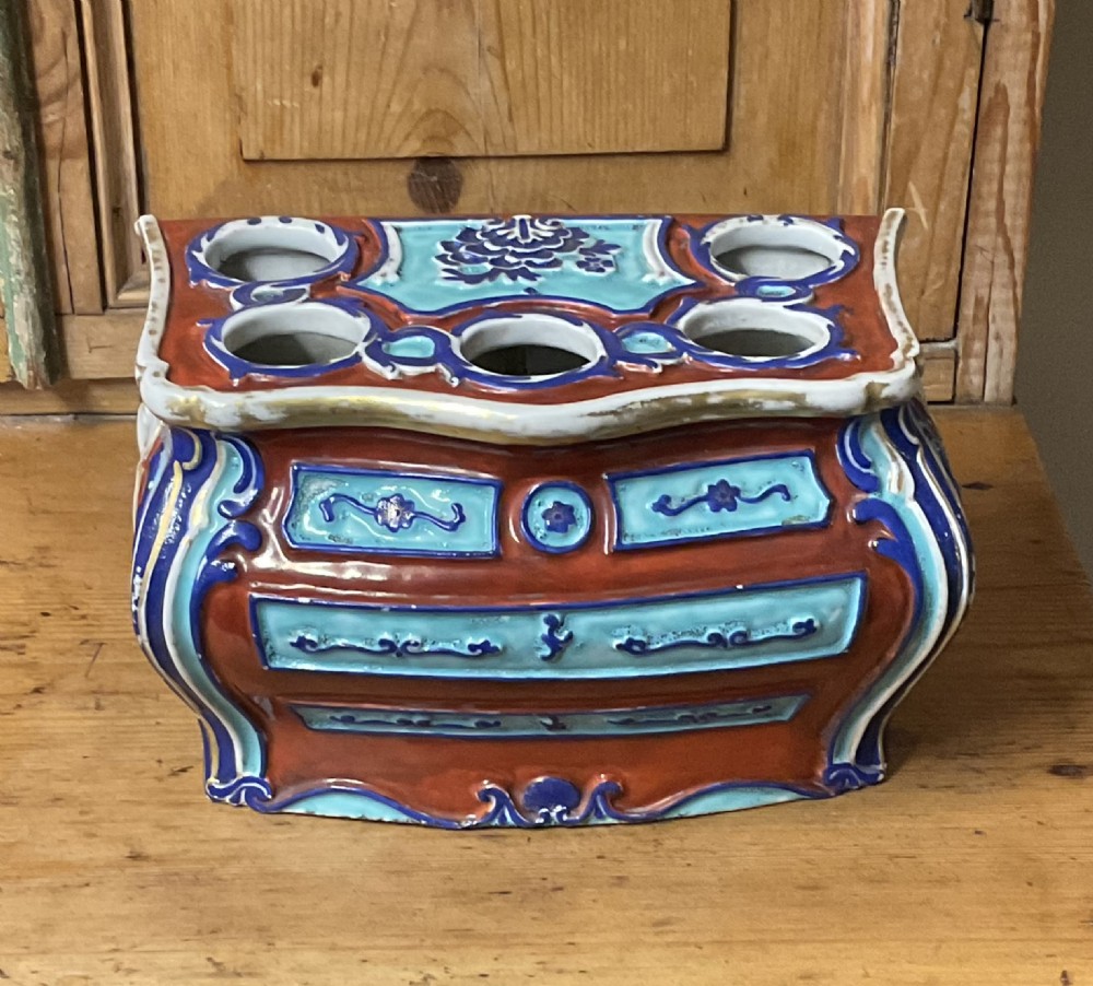 A Chinese export porcelain bough pot shaped like a Rococo commode decorated in terracotta, turquoise, and dark blue enamels with top apertures. View VII