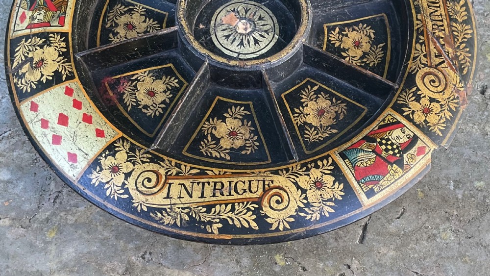 A circular 19th-century black lacquered revolving Pope Joan game board featuring gilt floral patterns and painted playing card designs. View III