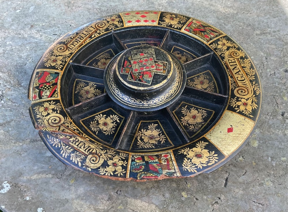 A circular 19th-century black lacquered revolving Pope Joan game board featuring gilt floral patterns and painted playing card designs. View VIII