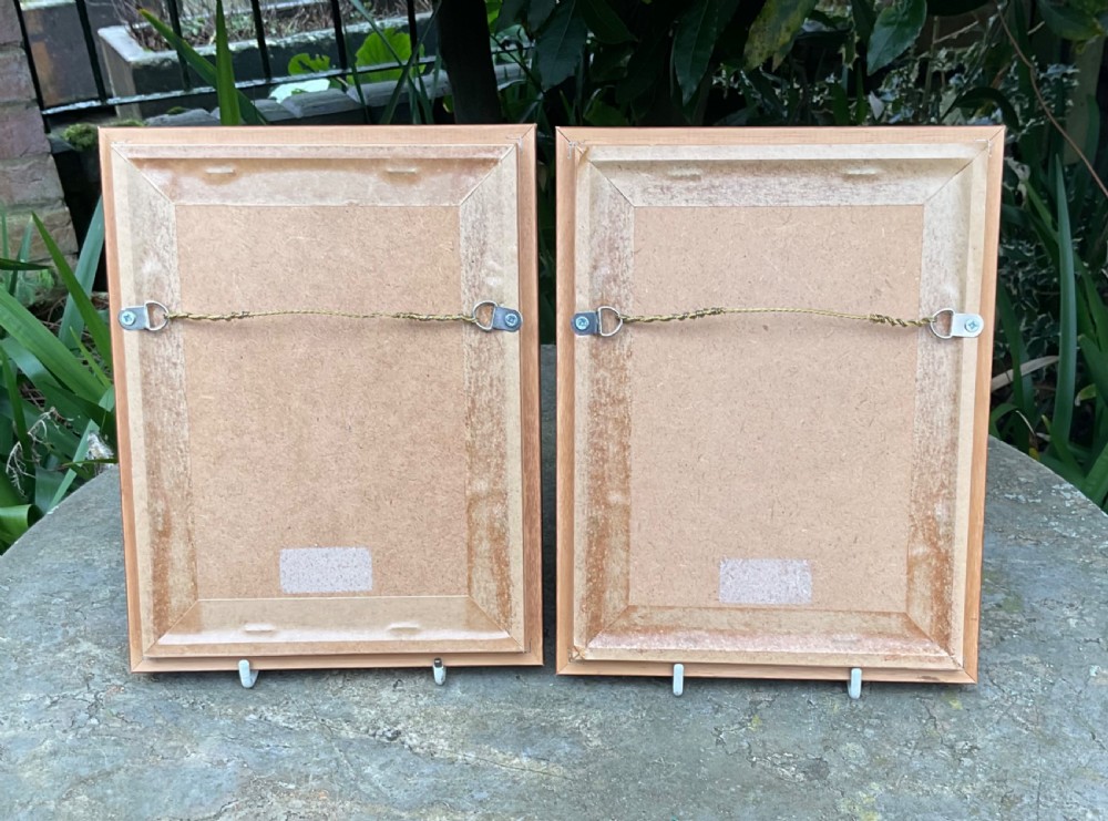 A pair of framed, warm brown glaze ceramic tiles depicting musician figures in sepia relief. View IV