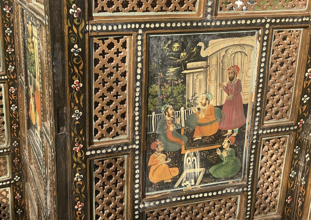 A four-panel wooden folding screen featuring intricate carved fretwork lattice panels and hand-painted figures set within decorative borders. View III