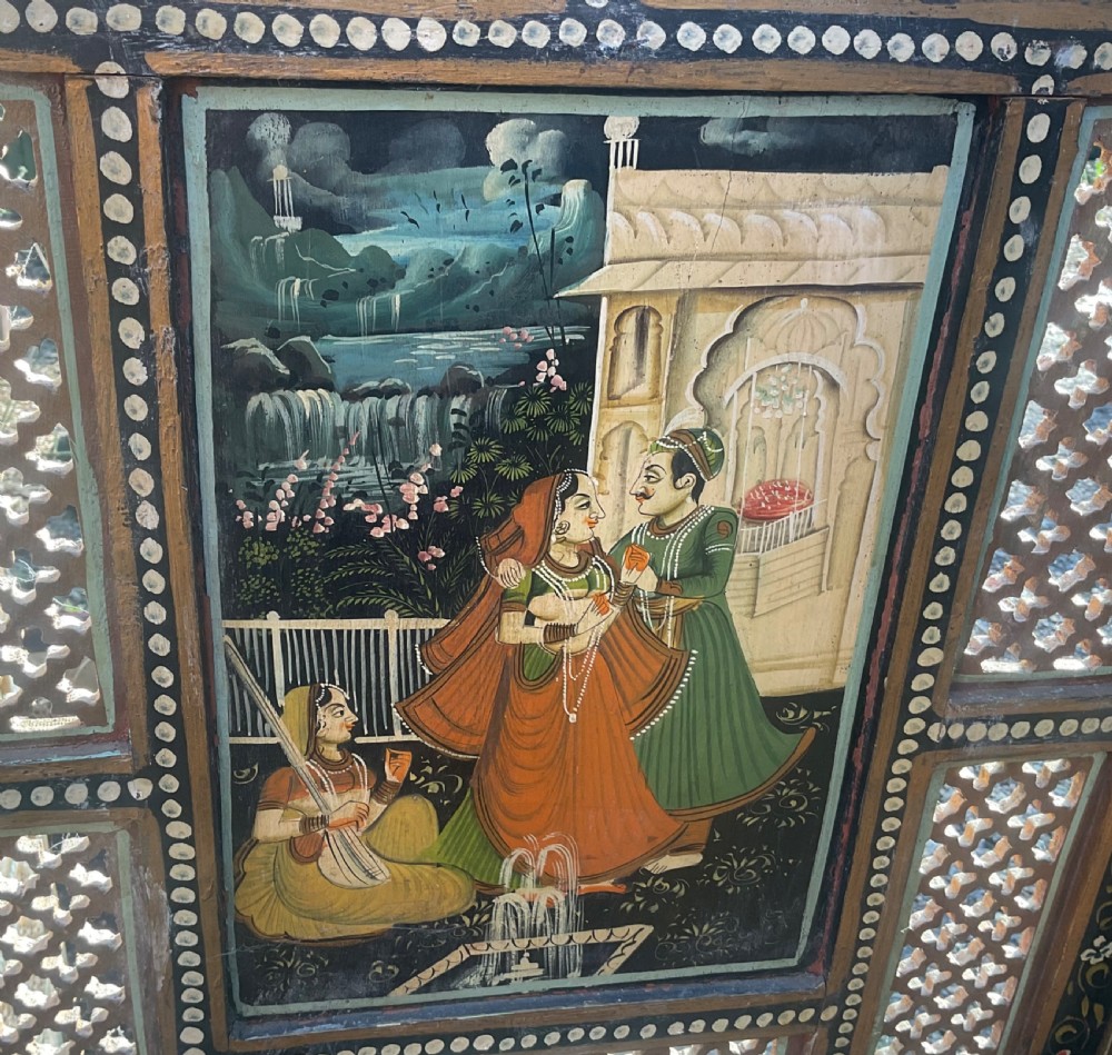 A four-panel wooden folding screen featuring intricate carved fretwork lattice panels and hand-painted figures set within decorative borders. View VIII