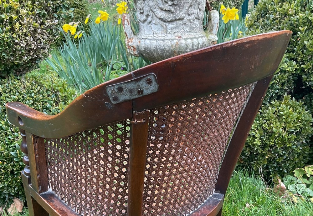 A child-sized antique Georgian armchair crafted from dark wood with hand-woven cane back, sides, and seat panels. View VI