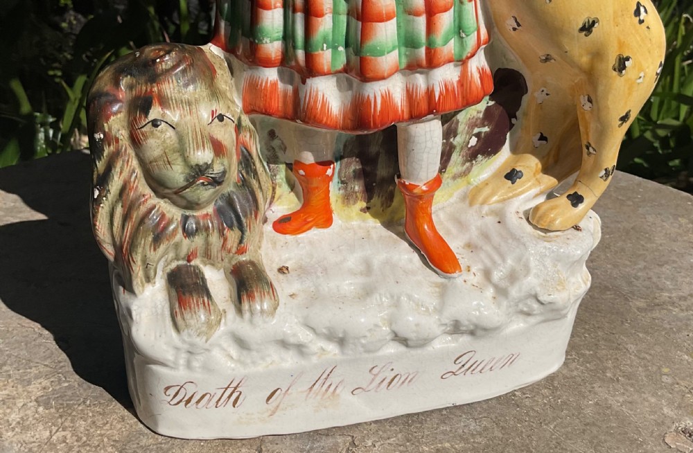 A Victorian Staffordshire earthenware pottery figure titled Death of the Lion Queen, featuring a female figure flanked by a leaping leopard and a seated lion. View VII