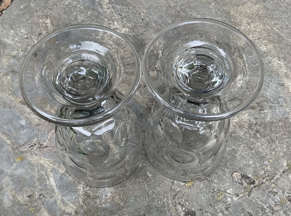A pair of clear Victorian glass rummers featuring wide bucket bowls decorated with cut lens patterns, resting on short faceted stems and broad flat circular bases. View IV