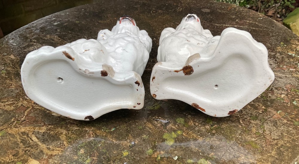 A pair of Victorian white ceramic Staffordshire spaniel figurines decorated with gilt accents and black painted muzzles. View V