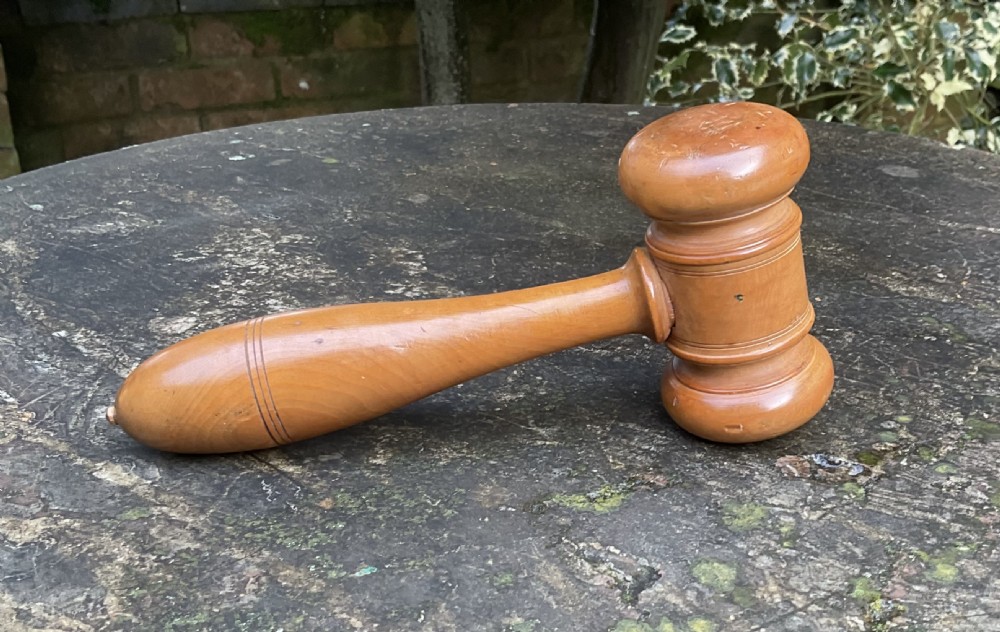 A turned Victorian boxwood gavel featuring a contoured handle with incised line detail and a cylindrical turned head with rounded ends.