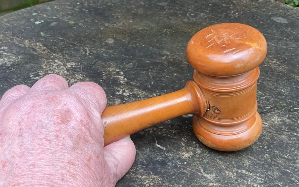 A turned Victorian boxwood gavel featuring a contoured handle with incised line detail and a cylindrical turned head with rounded ends. View V