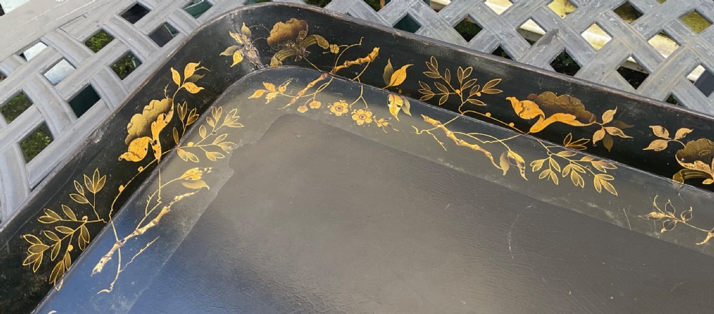 A large rectangular black lacquer papier-mache tray featuring rounded corners and a gilded floral border. View III