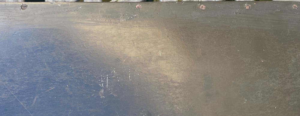 A large rectangular black lacquer papier-mache tray featuring rounded corners and a gilded floral border. View VI