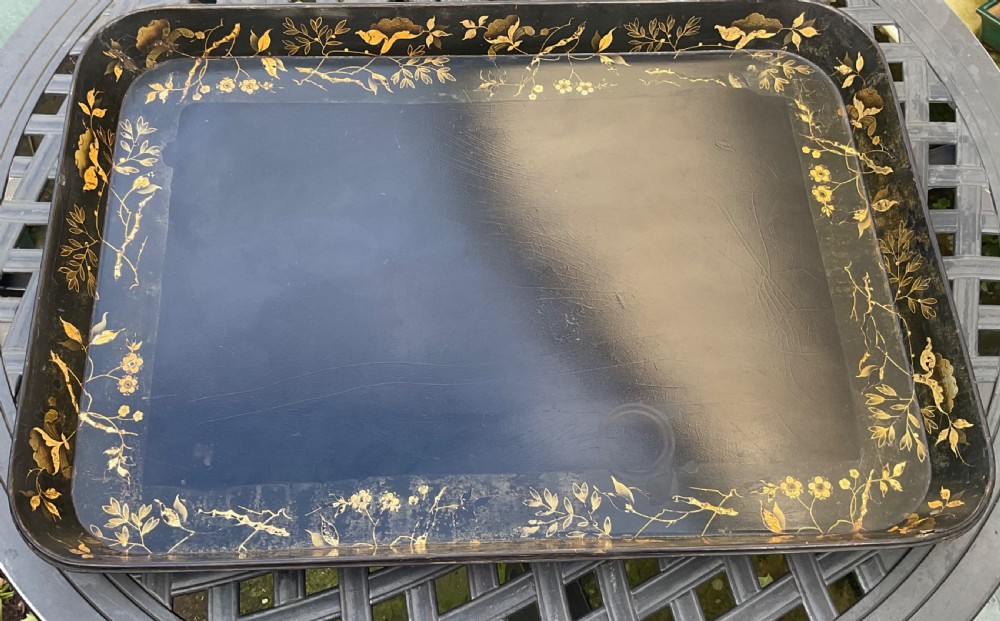 A large rectangular black lacquer papier-mache tray featuring rounded corners and a gilded floral border. View XI