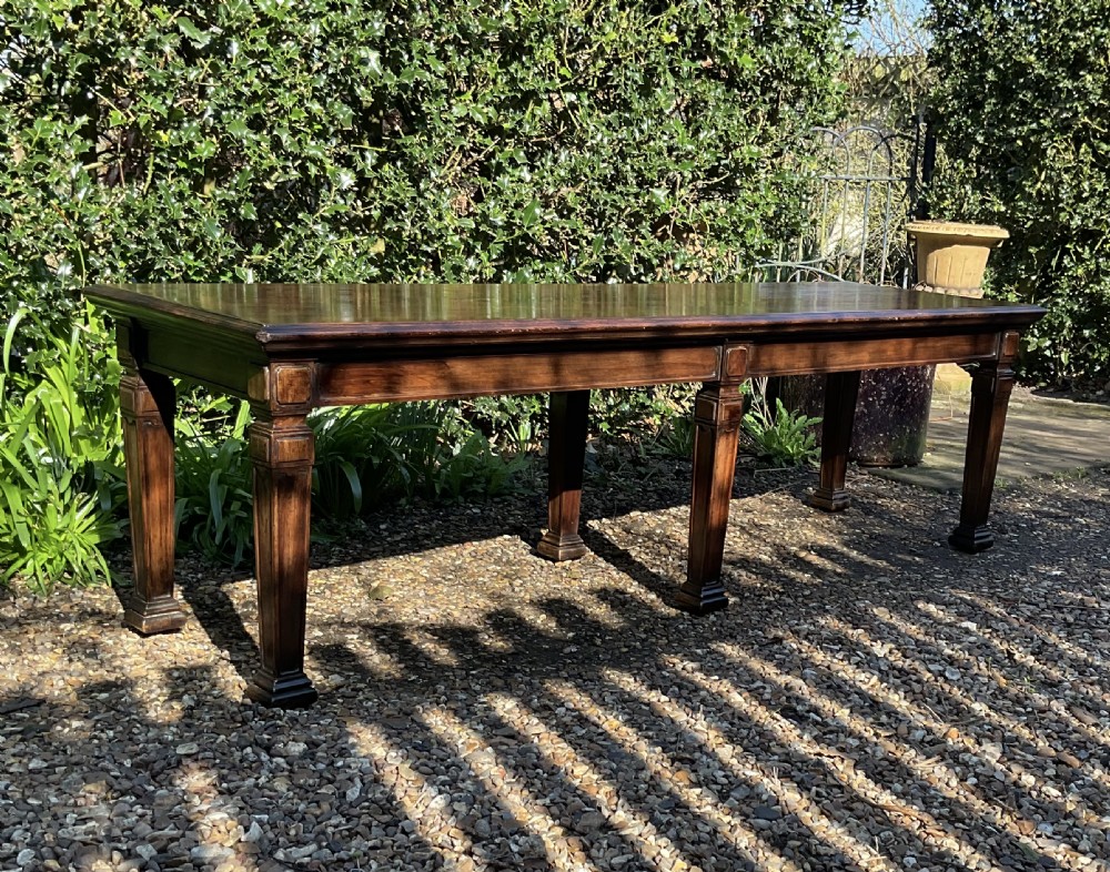 An Edwardian long polished mahogany window seat featuring a rectangular top and six tapered square legs with block details. View VI
