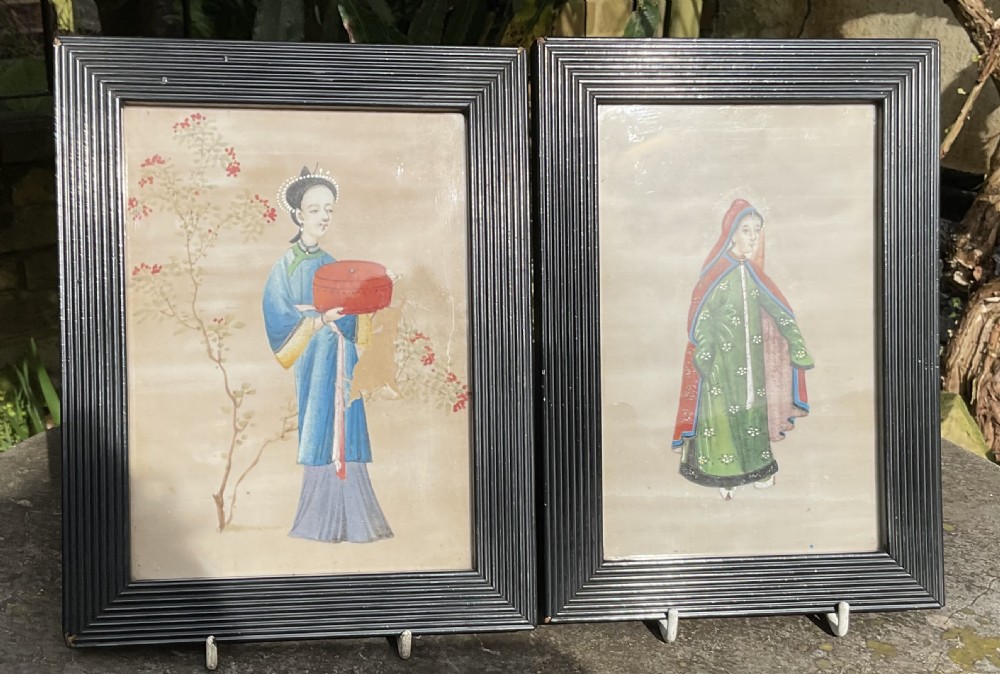 A pair of framed 19th-century Chinese pith paper gouache paintings depicting standing women in traditional robes set within dark ebonised reeded frames. View V