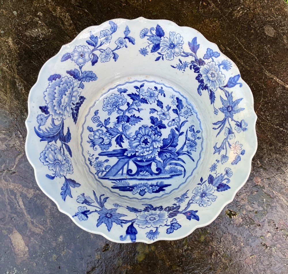 A Georgian blue and white transferware ceramic bowl with twin side handles, a floral pattern, and a raised pedestal foot. View II