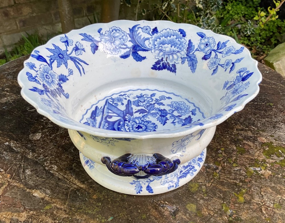 A Georgian blue and white transferware ceramic bowl with twin side handles, a floral pattern, and a raised pedestal foot. View III