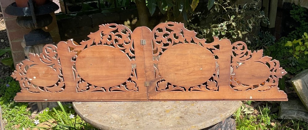 A Victorian three-tiered olive wood corner shelf with pierced fretwork edges and oval inlaid marquetry panels depicting Italian figures. View VII