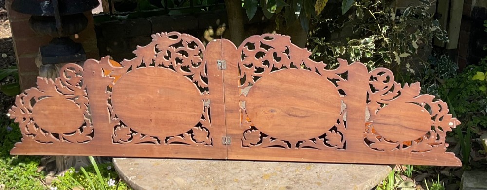 A Victorian three-tiered olive wood corner shelf with pierced fretwork edges and oval inlaid marquetry panels depicting Italian figures. View VIII