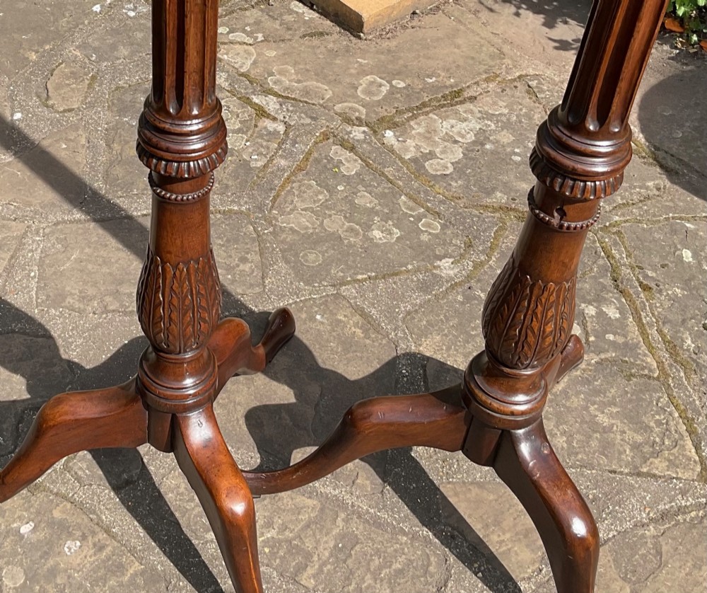 A pair of tall Georgian mahogany standard lamps featuring reeded columns, carved acanthus leaves, and tripod bases with cabriole legs. View V