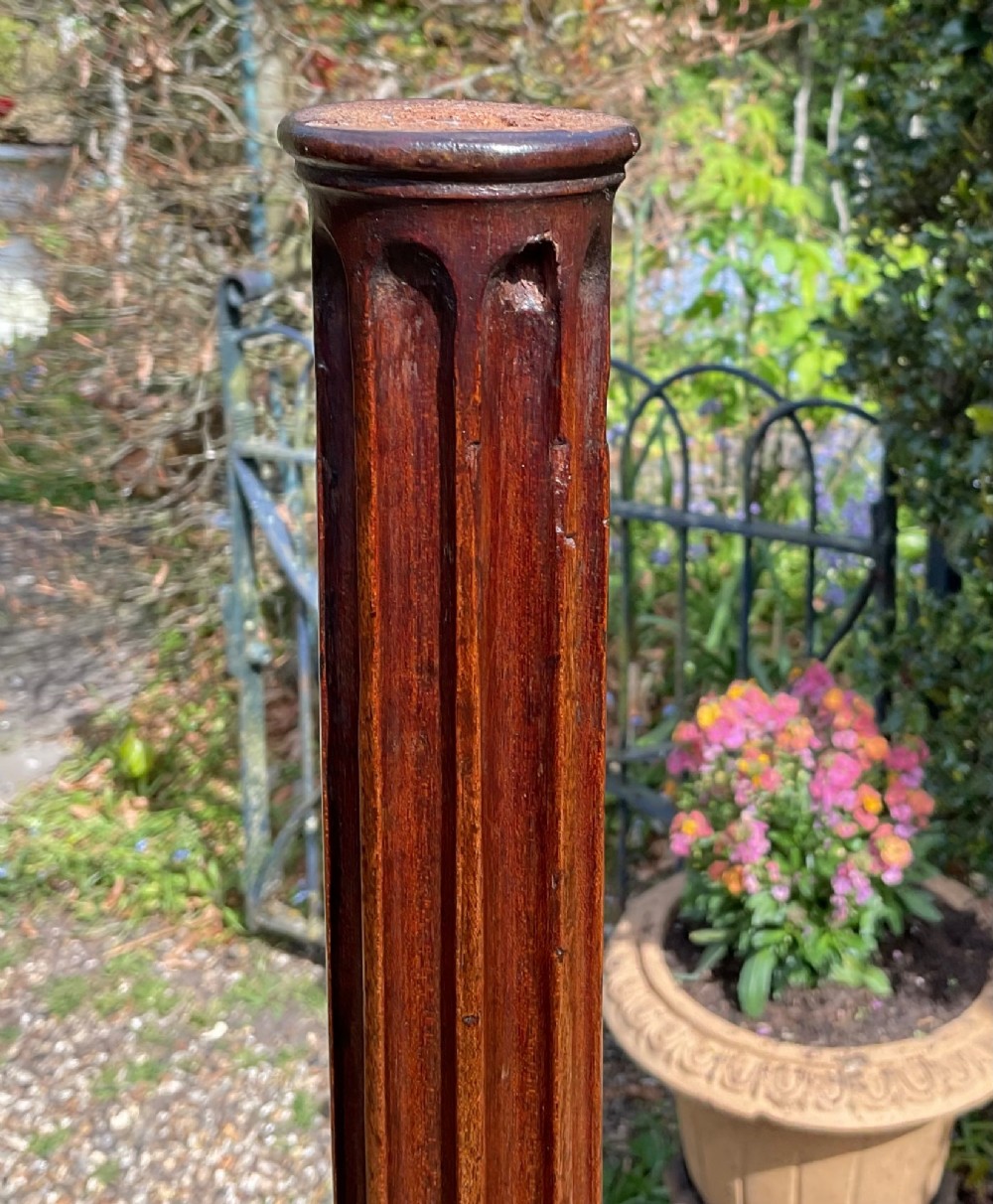 A pair of tall Georgian mahogany standard lamps featuring reeded columns, carved acanthus leaves, and tripod bases with cabriole legs. View VI