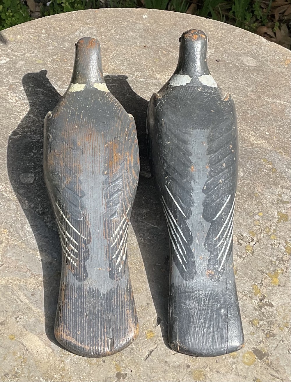 A pair of hand-carved and painted wooden pigeon decoys dating to circa 1900, showing grey and terracotta tones with worn patina. View II