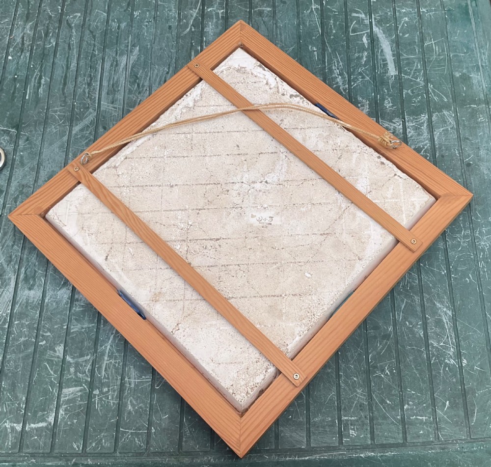 An Edwardian diamond-shaped Mintons ceramic tile mounted in a wooden frame depicting a detailed blue transfer print of a bull head. View II