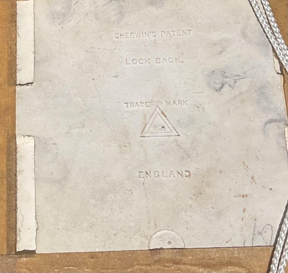 A pair of square sepia-toned glazed ceramic tiles featuring relief portraits of a bull and a cow, each enclosed within a wooden oak frame. View III