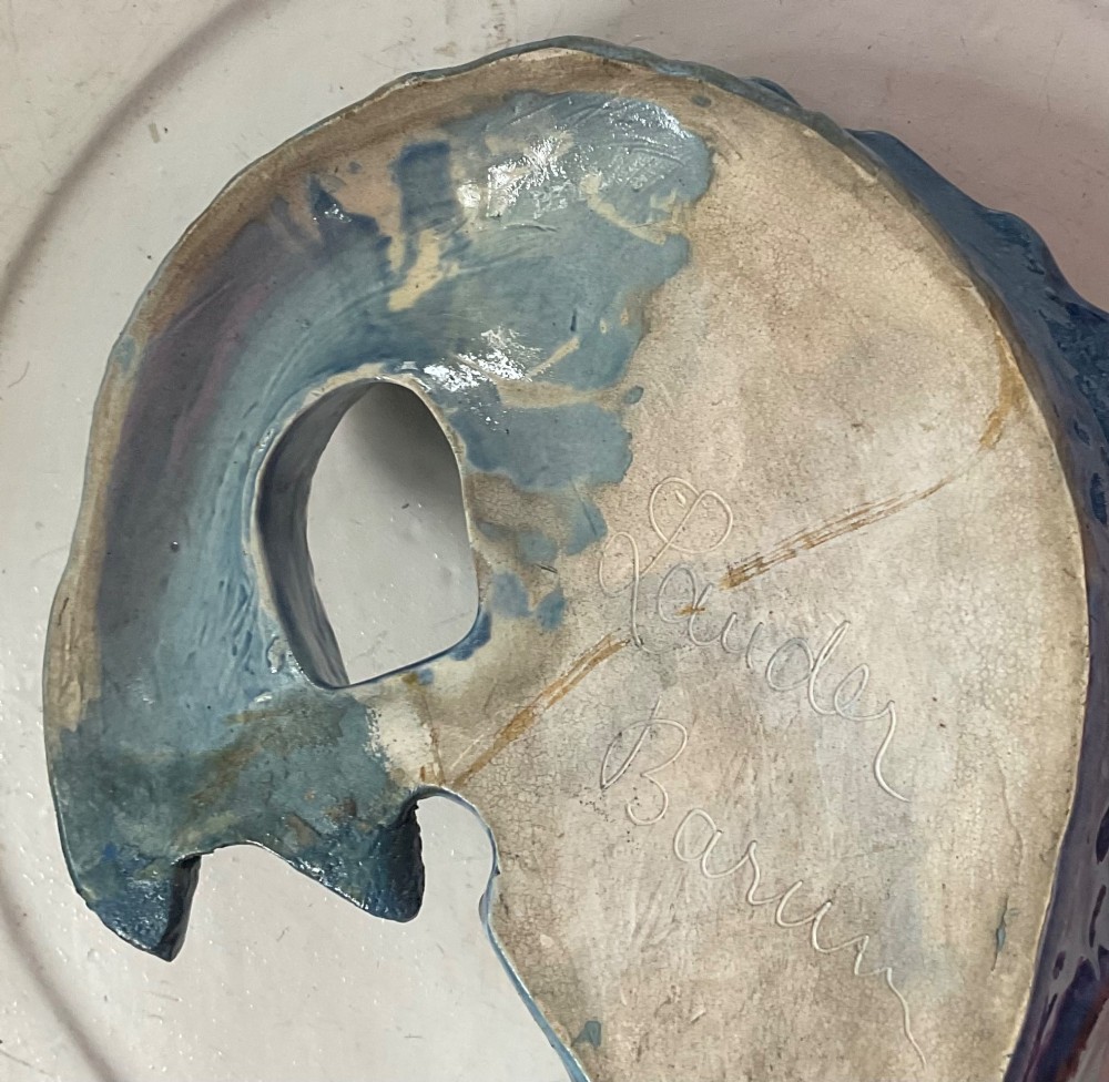 A glazed earthenware wall pocket modelled in the form of a fish with blue scales, green fins, and an open mouth vessel. View V