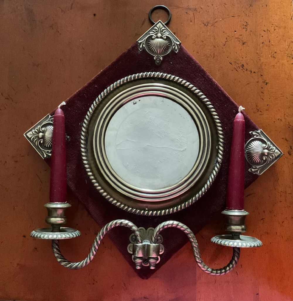 A pair of diamond-shaped Victorian girandole mirrors featuring burgundy velvet fabric, brass shell corner mounts, circular mirrors, and twin brass candle branches. View II
