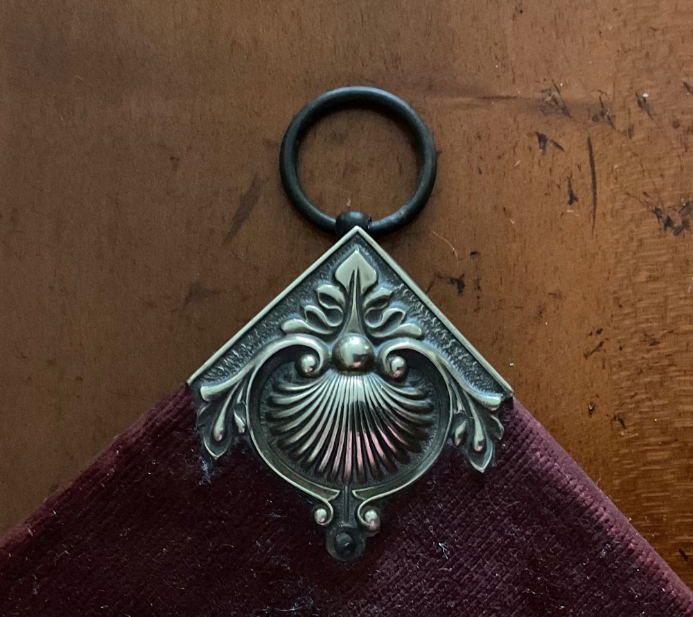 A pair of diamond-shaped Victorian girandole mirrors featuring burgundy velvet fabric, brass shell corner mounts, circular mirrors, and twin brass candle branches. View III