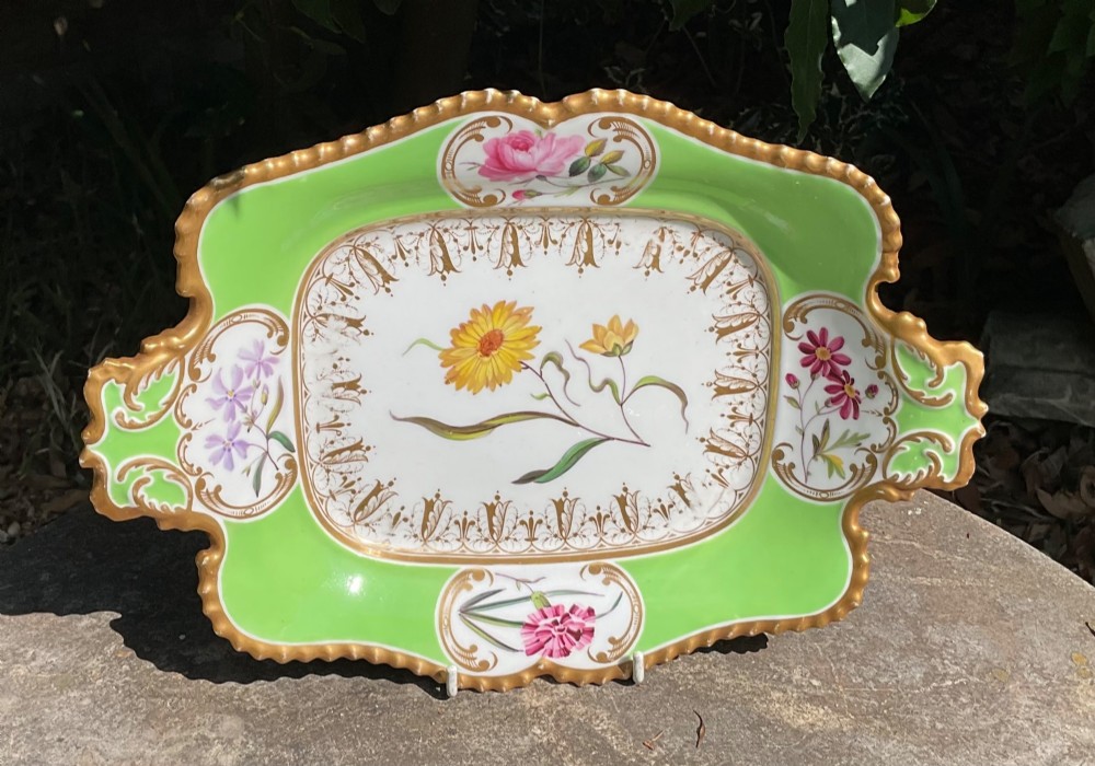 A set of four Regency period Chamberlains Worcester porcelain serving dishes featuring bright apple green borders, gilt scrollwork, and individual hand-painted central botanical flowers. View III