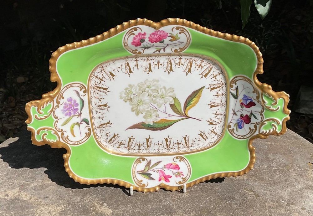 A set of four Regency period Chamberlains Worcester porcelain serving dishes featuring bright apple green borders, gilt scrollwork, and individual hand-painted central botanical flowers. View V