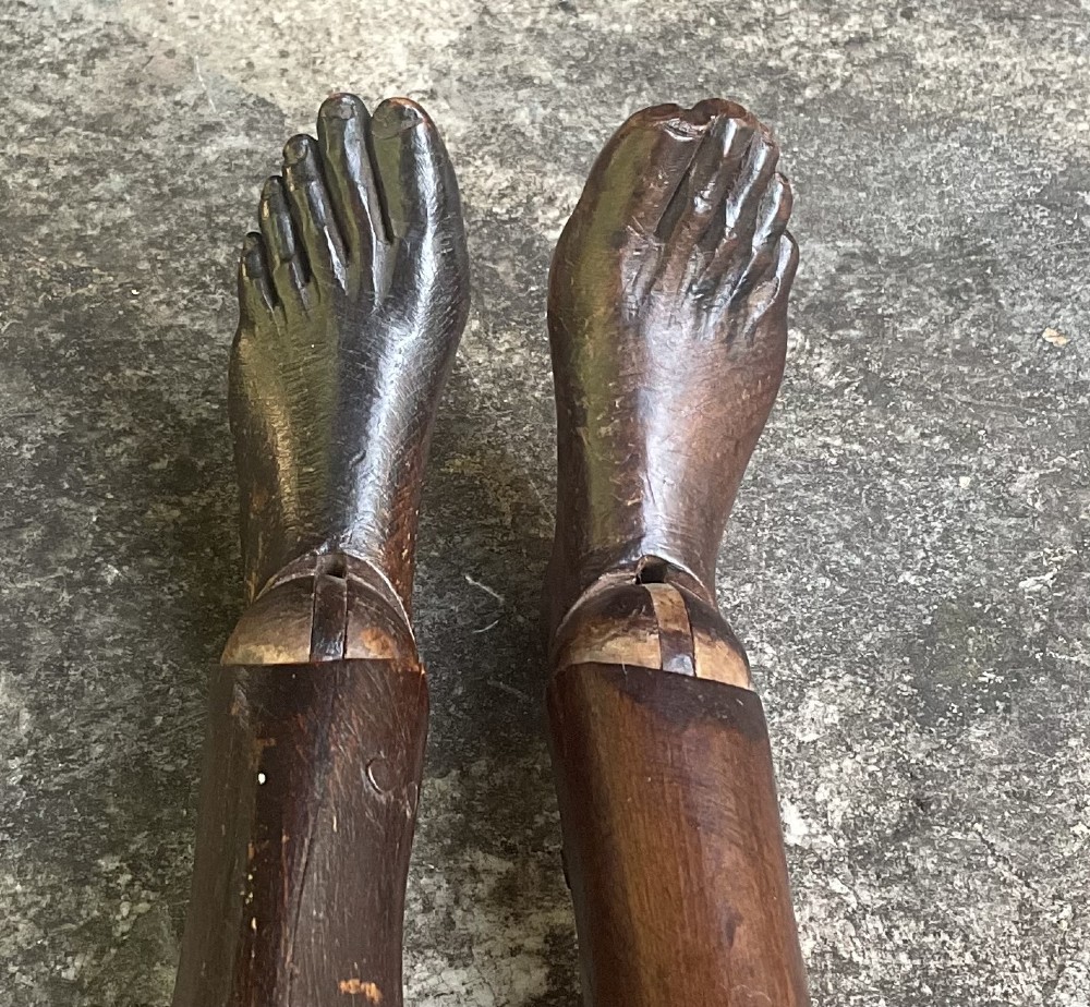 A nineteenth-century articulated carved dark wood artists lay figure seated with crossed legs and posed arms. View IV