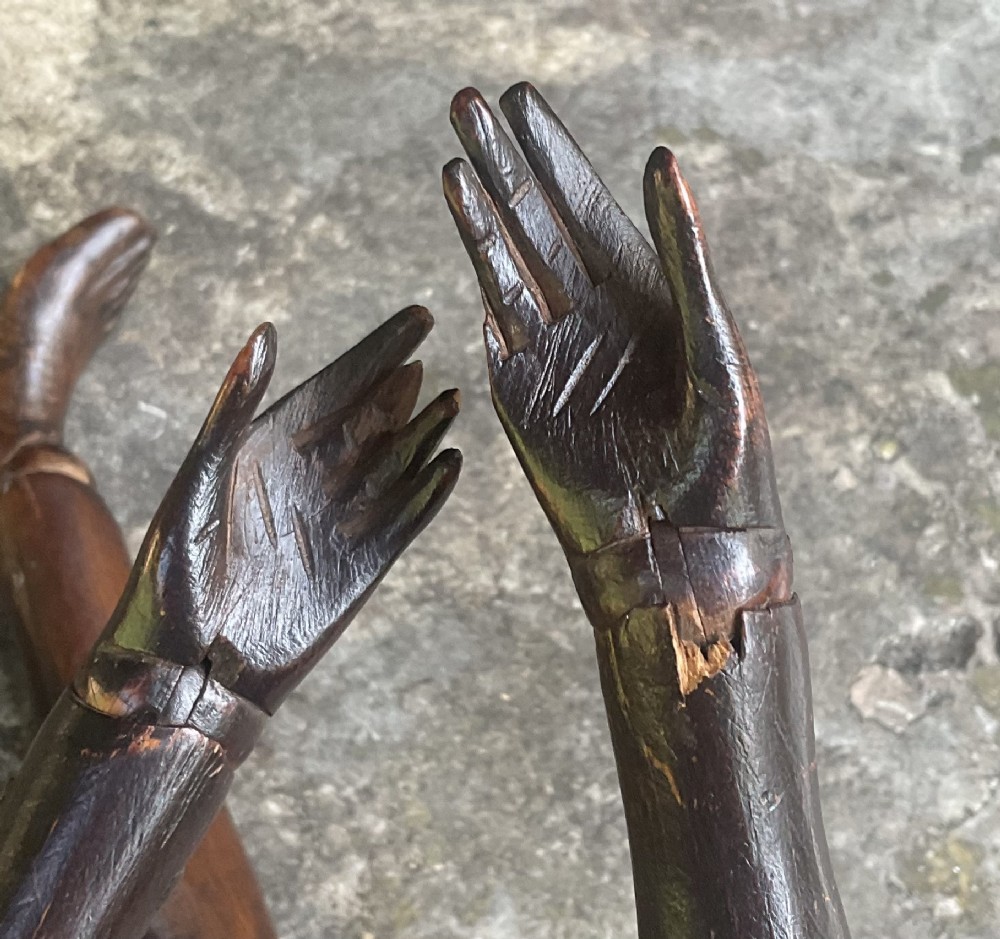 A nineteenth-century articulated carved dark wood artists lay figure seated with crossed legs and posed arms. View V