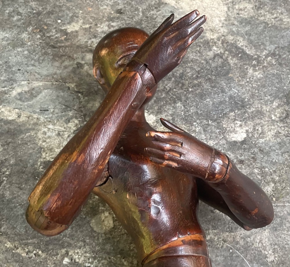 A nineteenth-century articulated carved dark wood artists lay figure seated with crossed legs and posed arms. View VI