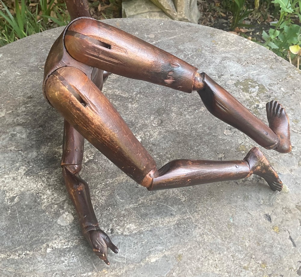 A nineteenth-century articulated carved dark wood artists lay figure seated with crossed legs and posed arms. View VIII