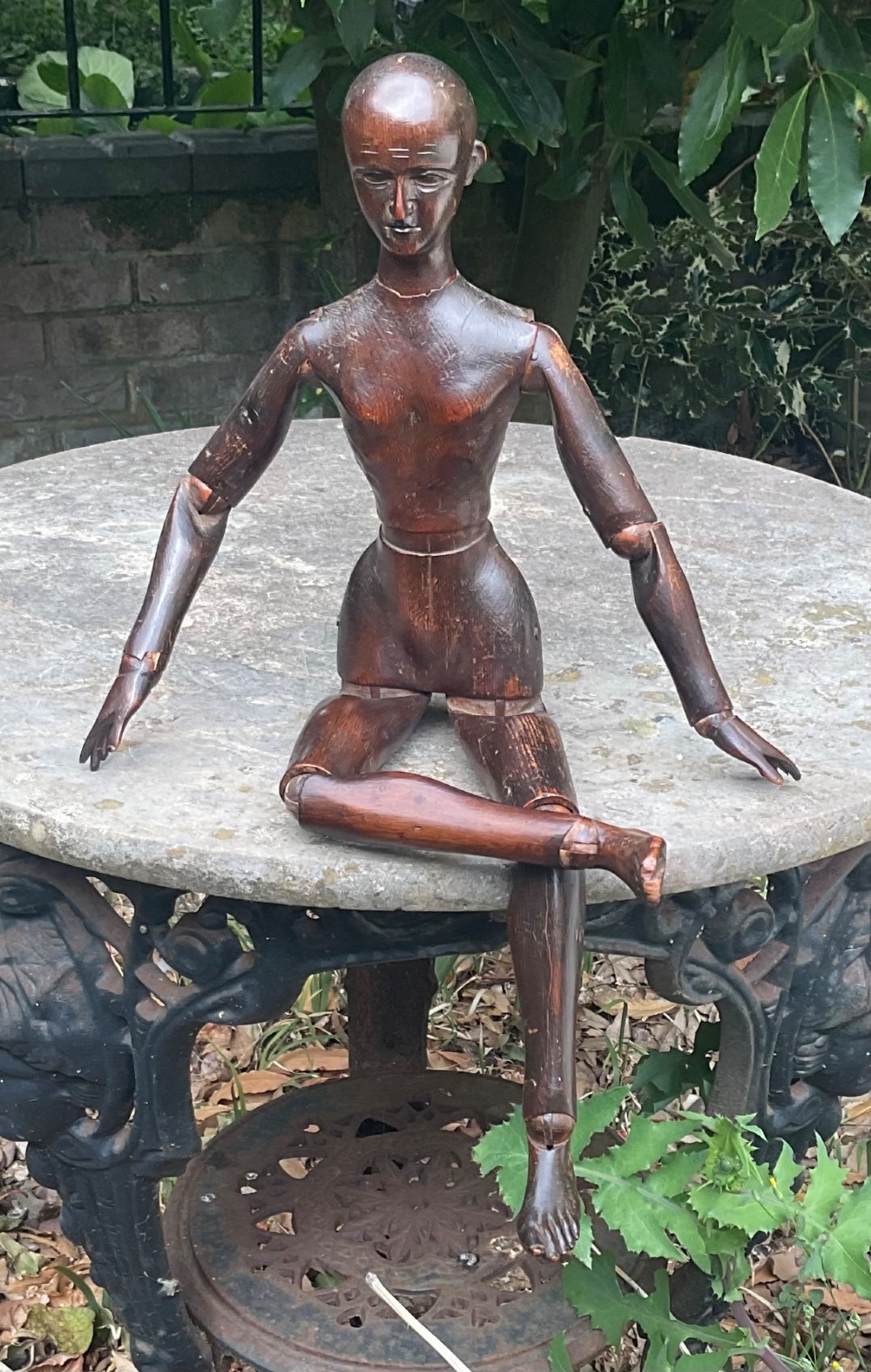 A nineteenth-century articulated carved dark wood artists lay figure seated with crossed legs and posed arms. View IX