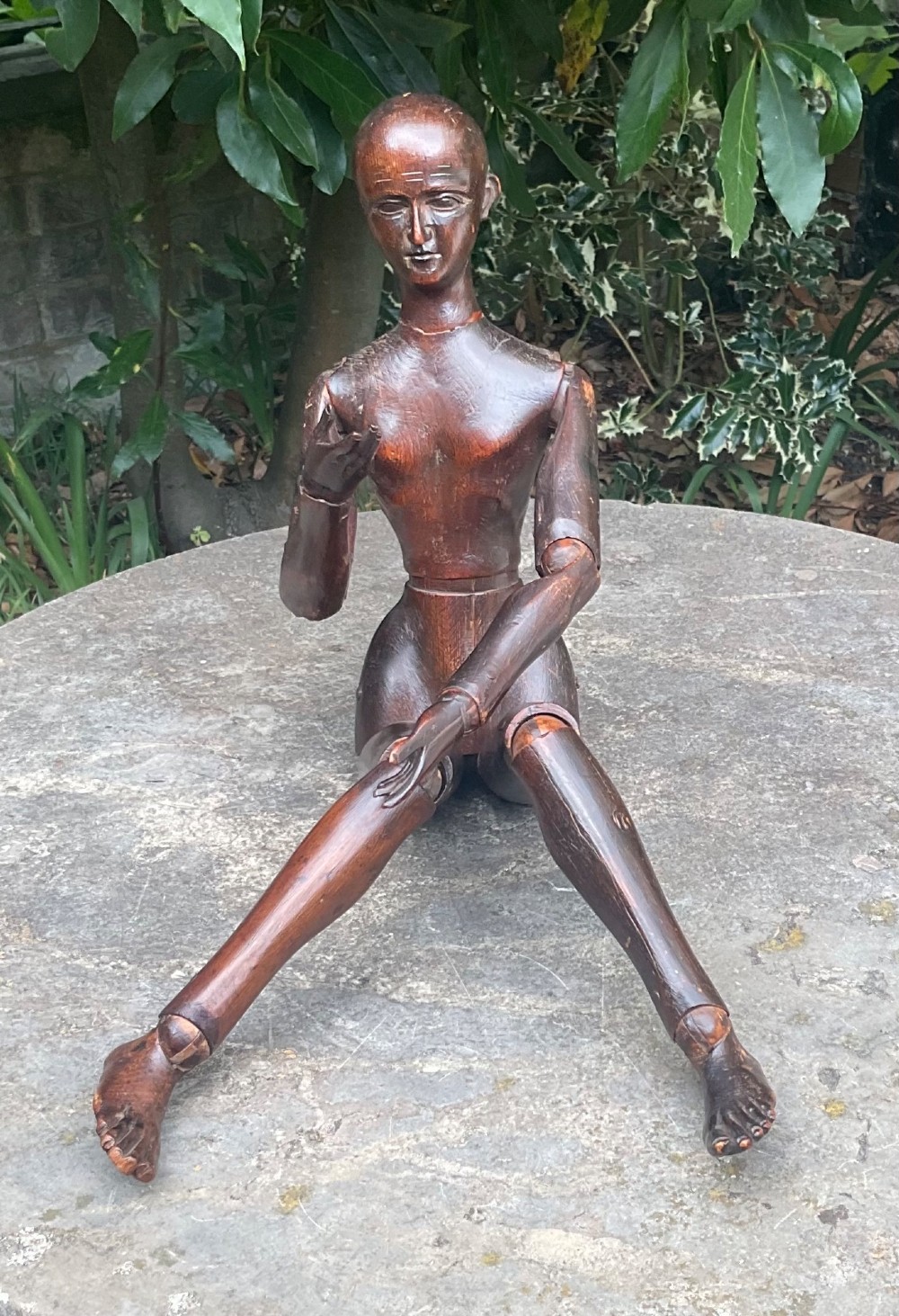 A nineteenth-century articulated carved dark wood artists lay figure seated with crossed legs and posed arms. View XI