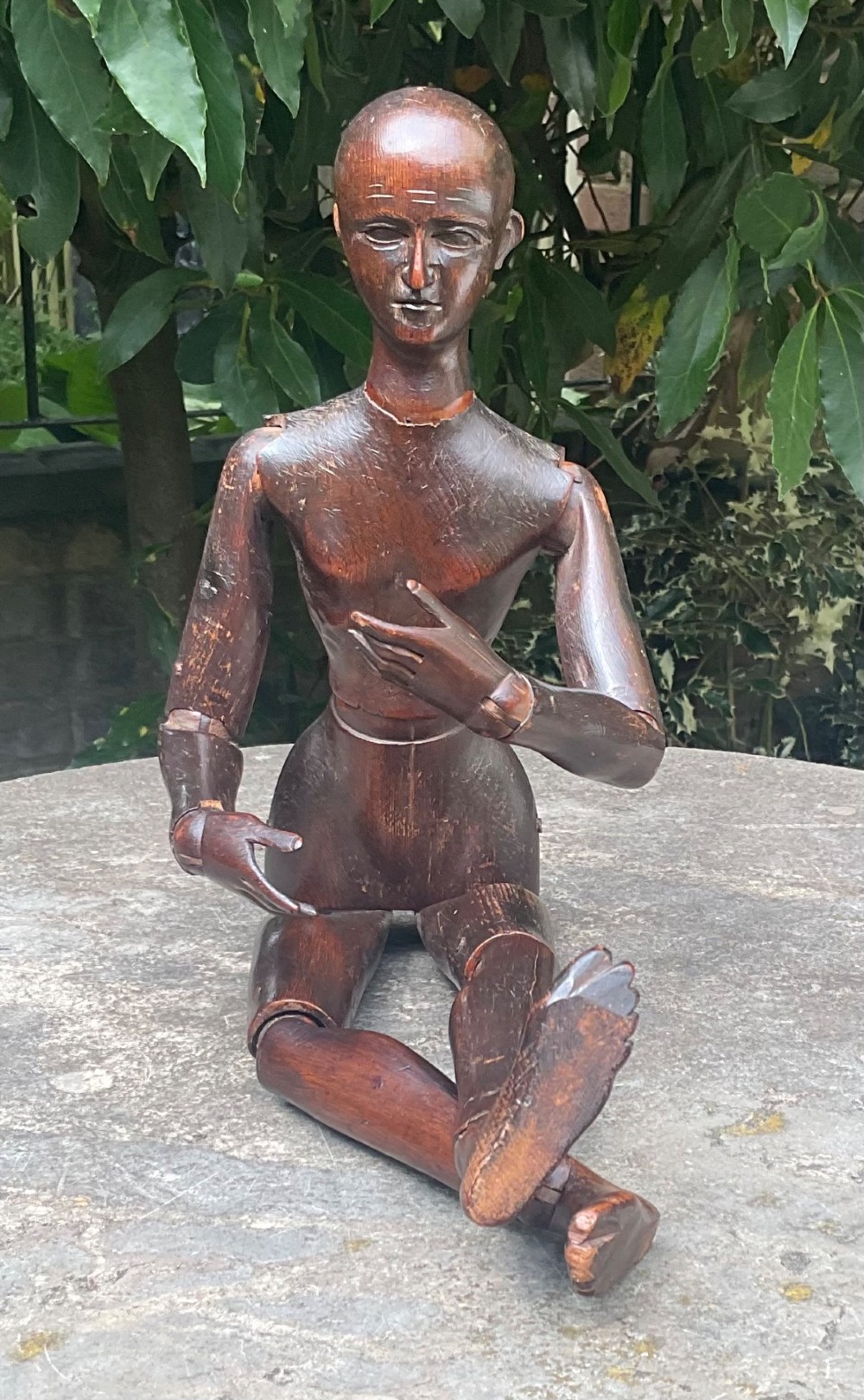 A nineteenth-century articulated carved dark wood artists lay figure seated with crossed legs and posed arms. View XV