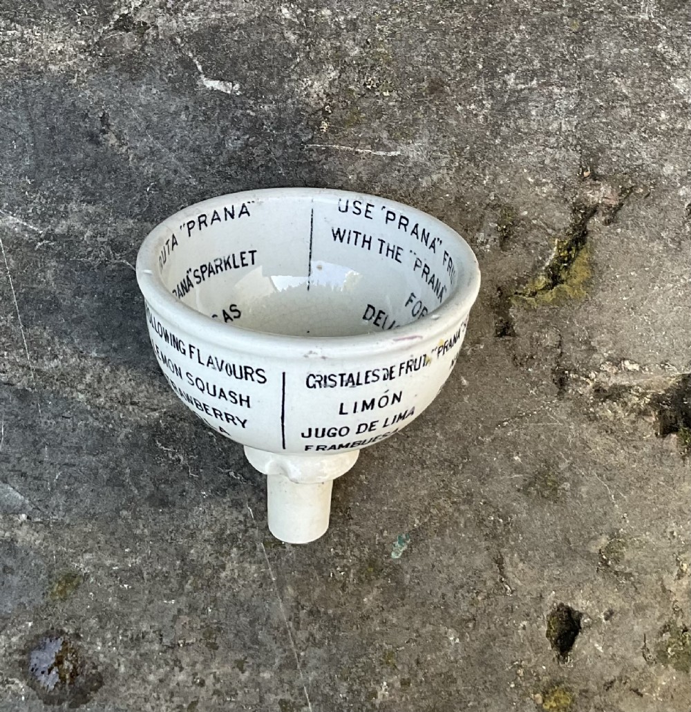 A cream glazed ceramic funnel printed with black Edwardian commercial typography for Prana Fruit Crystals. View II
