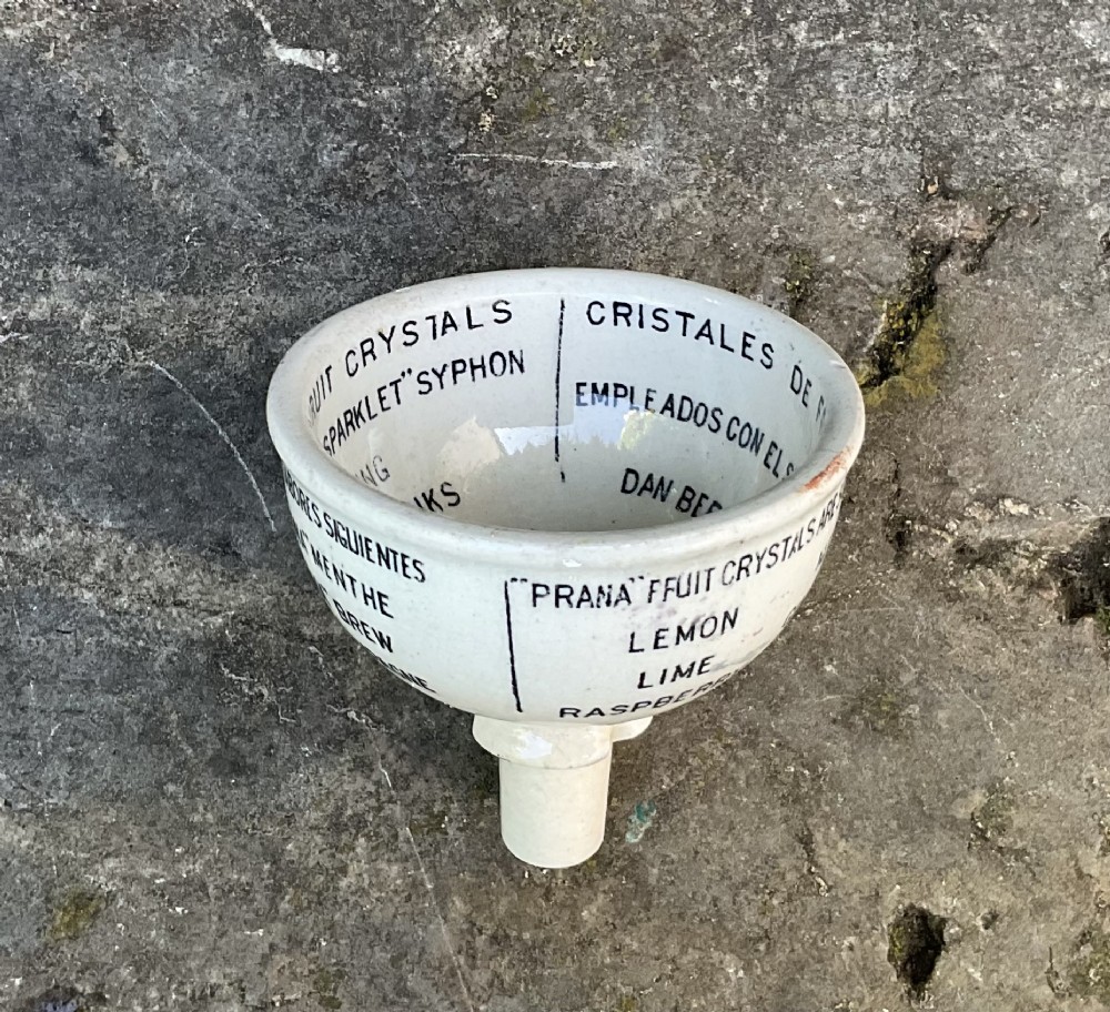 A cream glazed ceramic funnel printed with black Edwardian commercial typography for Prana Fruit Crystals. View III