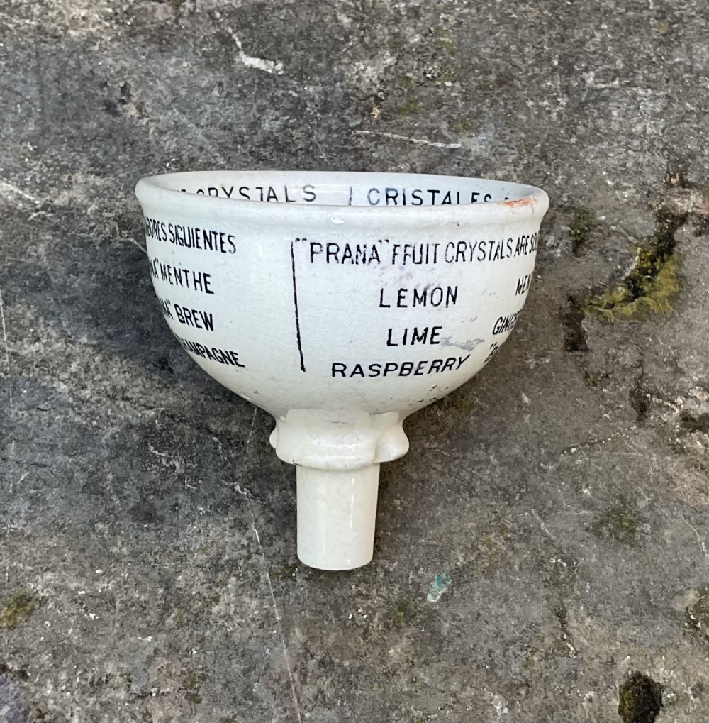A cream glazed ceramic funnel printed with black Edwardian commercial typography for Prana Fruit Crystals. View V