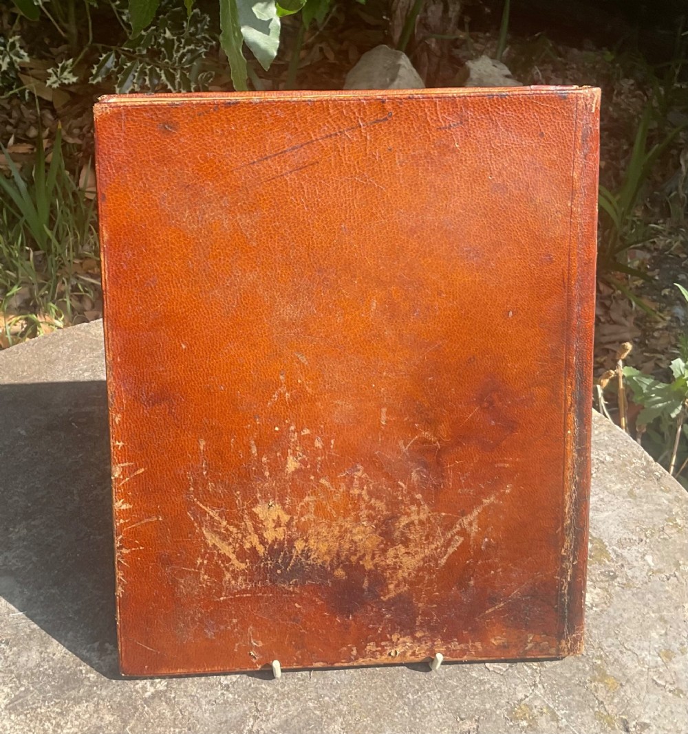 An antique brown leather desk blotter featuring a central embossed copper relief panel depicting a scene from Wagners opera Lohengrin with a knight and swan. View III