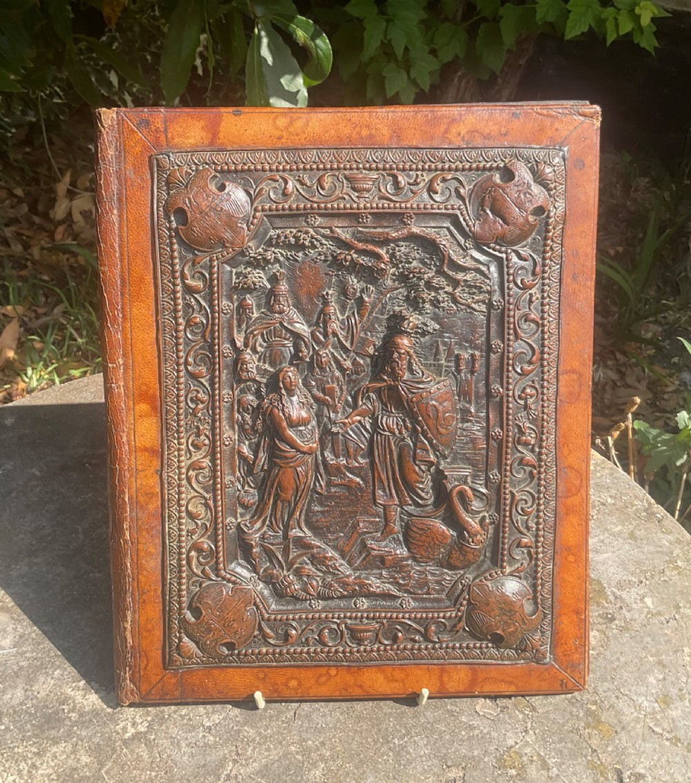 An antique brown leather desk blotter featuring a central embossed copper relief panel depicting a scene from Wagners opera Lohengrin with a knight and swan. View VI