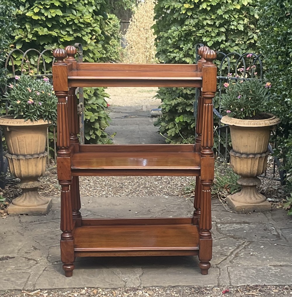 A Victorian mahogany three-tier etagere featuring reeded vertical supports, turned finials, and gallery rimmed shelves. View II